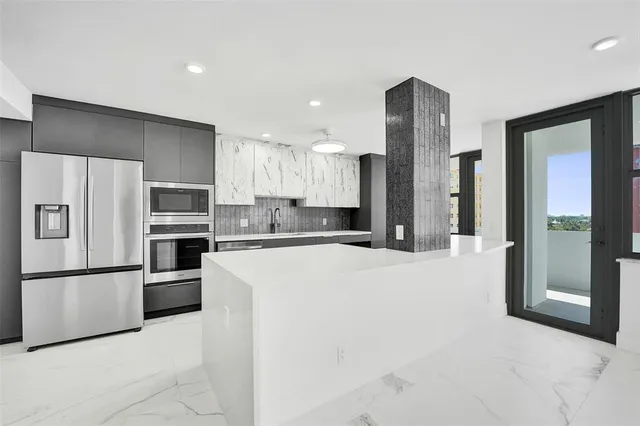 a kitchen with cabinets and stainless steel appliances
