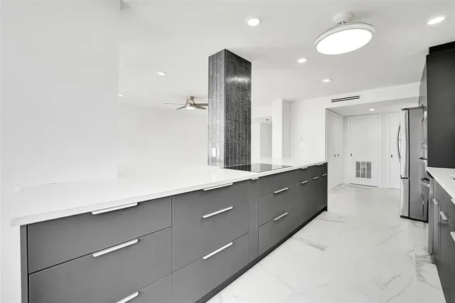 a kitchen with a sink cabinets and stainless steel appliances