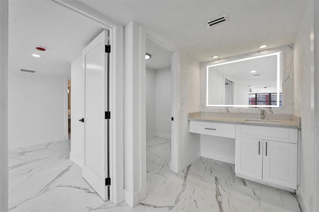 1390 South Ocean Boulevard, Unit 5C Pompano Beach, FL 33062 - Photo 24 of 35 a bathroom with a sink and a mirror