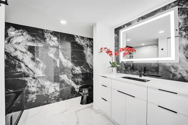 a bathroom with a bathtub and shower