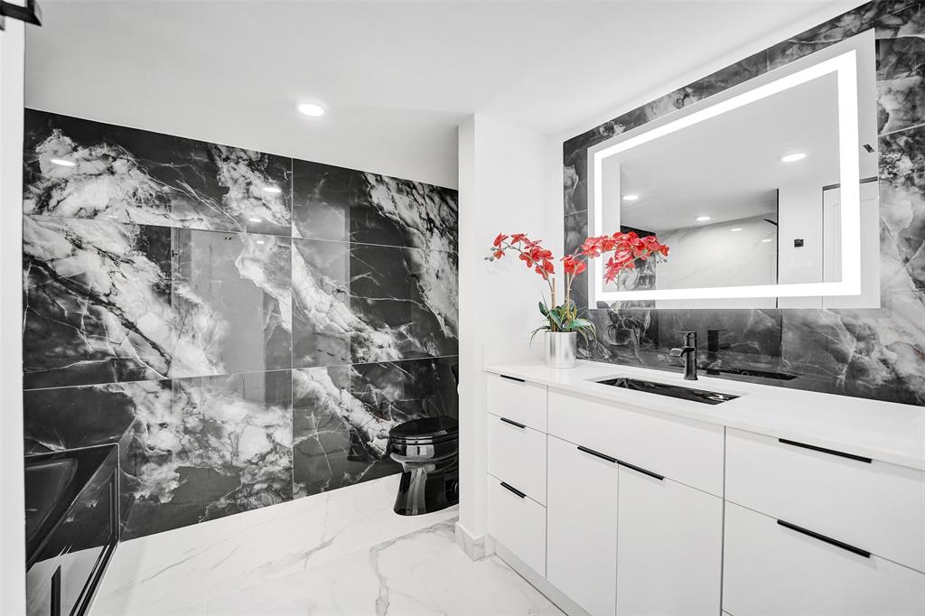 1390 South Ocean Boulevard, Unit 5C Pompano Beach, FL 33062 - Photo 30 of 35 a bathroom with a sink and a mirror