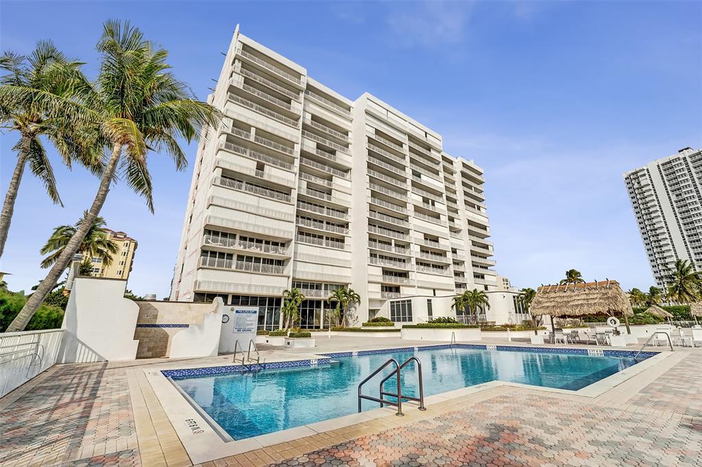 1390 South Ocean Boulevard, Unit 5C Pompano Beach, FL 33062 - Photo 3 of 35 a view of a swimming pool with a lounge chairs