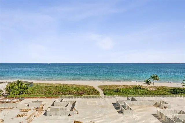a view of a field with an ocean