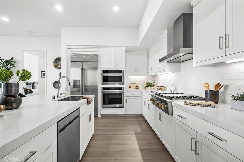 3604 Rivington Irvine, CA 92612 - Photo 13 of 54 a kitchen with stainless steel appliances a sink stove and cabinets