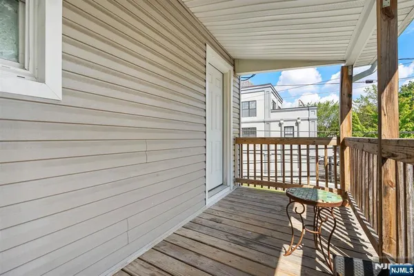 a view of a balcony with wooden floor