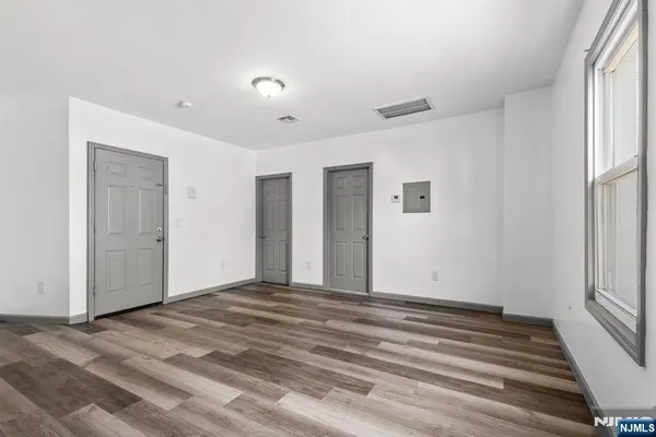 a view of a livingroom with wooden floor and window