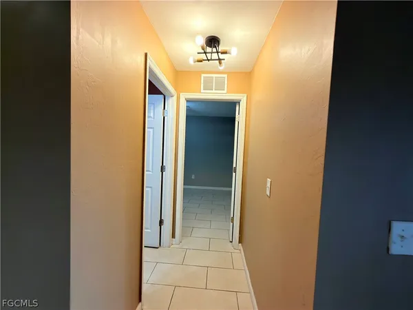 a view of a hallway to rooms