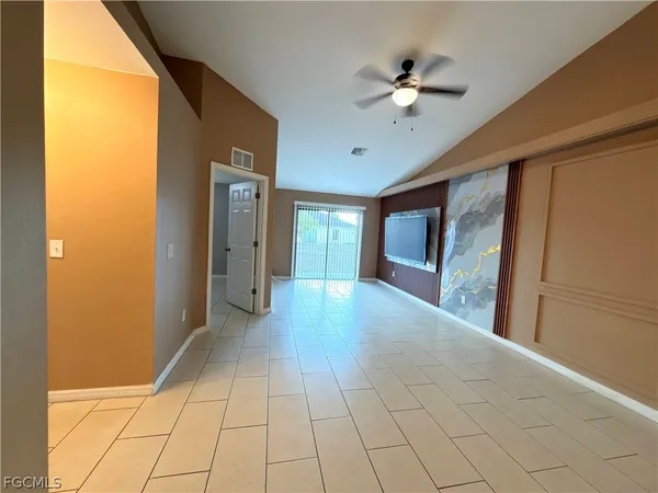 a view of an entryway with a chandelier fan