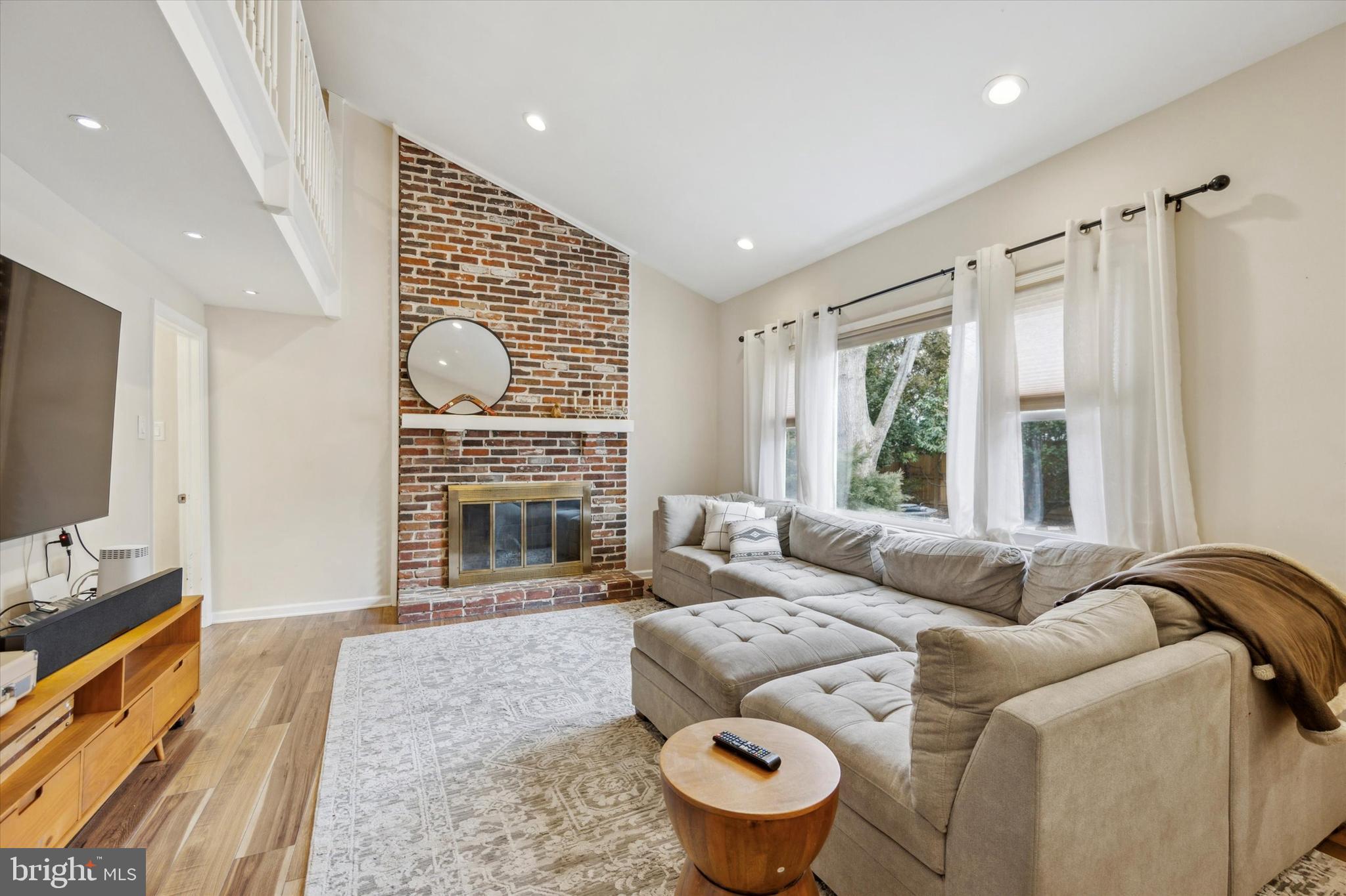 411 Silver Hill Road Cherry Hill, NJ 08002 - Photo 11 of 29 a living room with furniture a fireplace and a flat screen tv