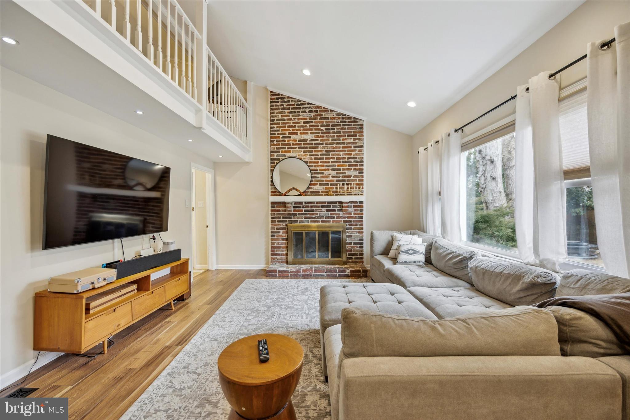 411 Silver Hill Road Cherry Hill, NJ 08002 - Photo 14 of 29 a living room with furniture a flat screen tv and a fireplace