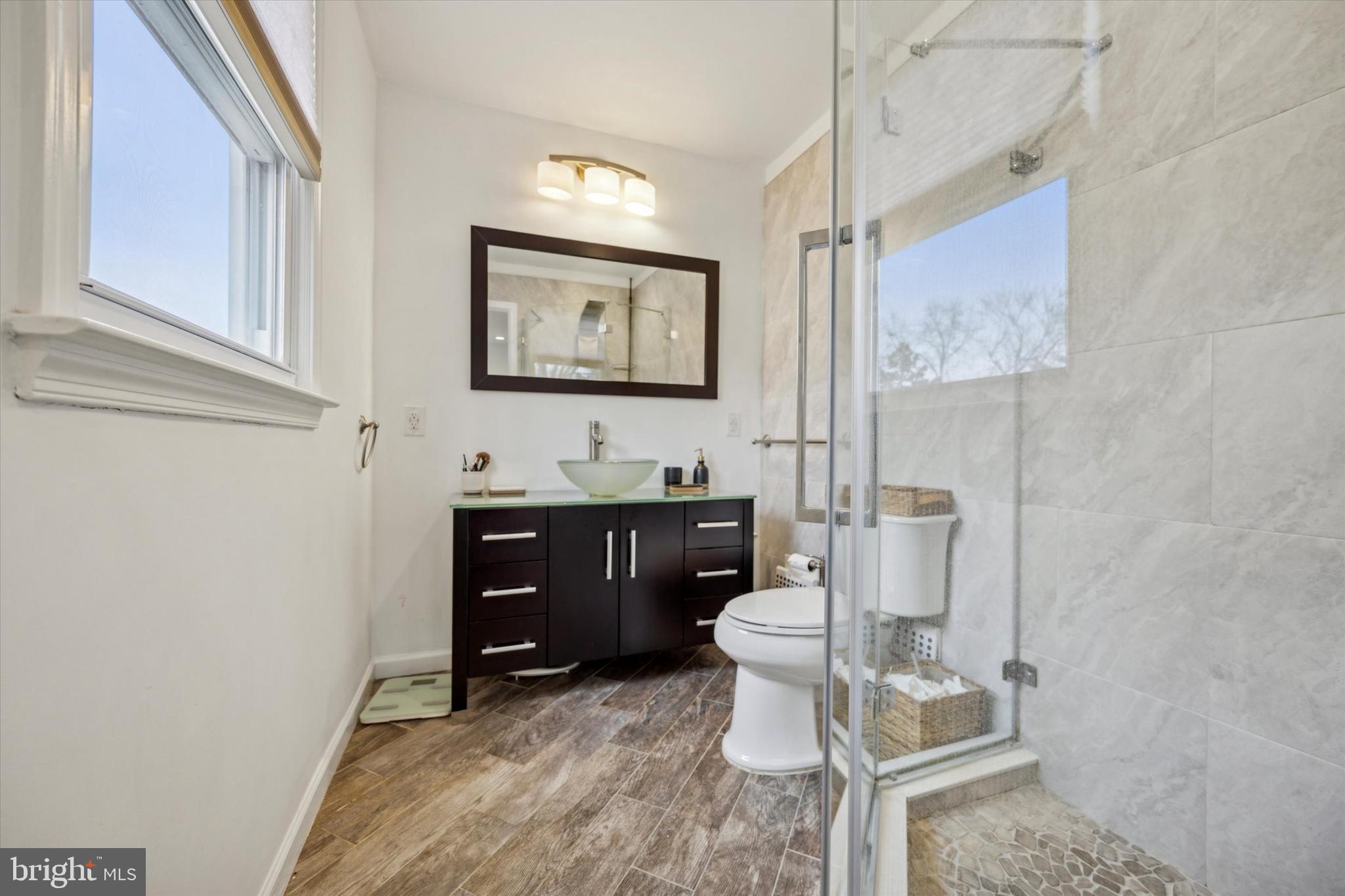 411 Silver Hill Road Cherry Hill, NJ 08002 - Photo 20 of 29 a bathroom with a toilet a sink and mirror