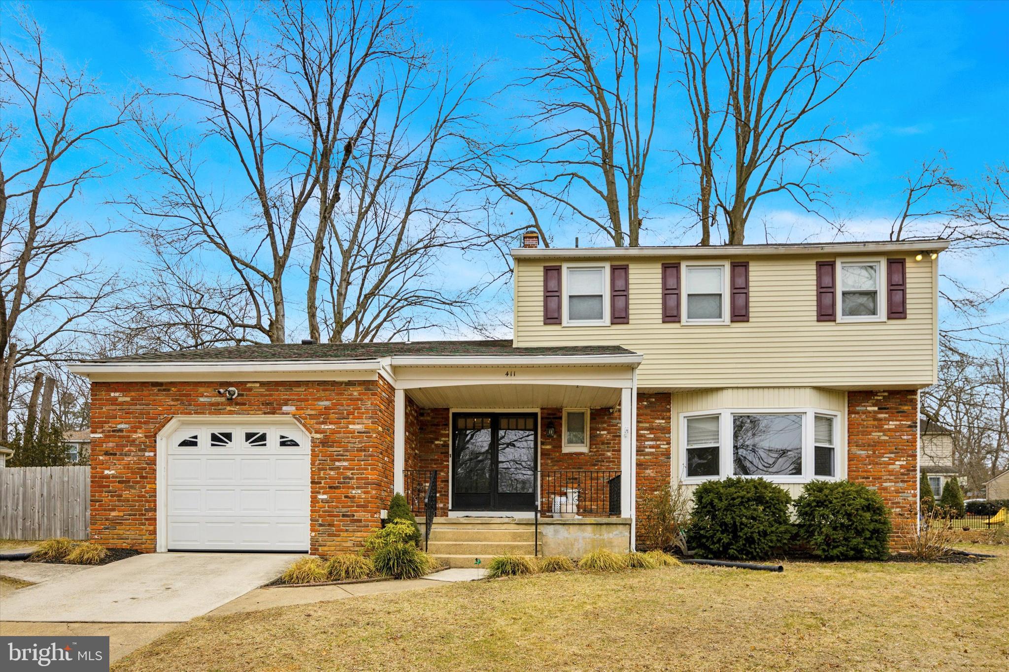 411 Silver Hill Road Cherry Hill, NJ 08002 - Photo 2 of 29 front view of a brick house with a tree