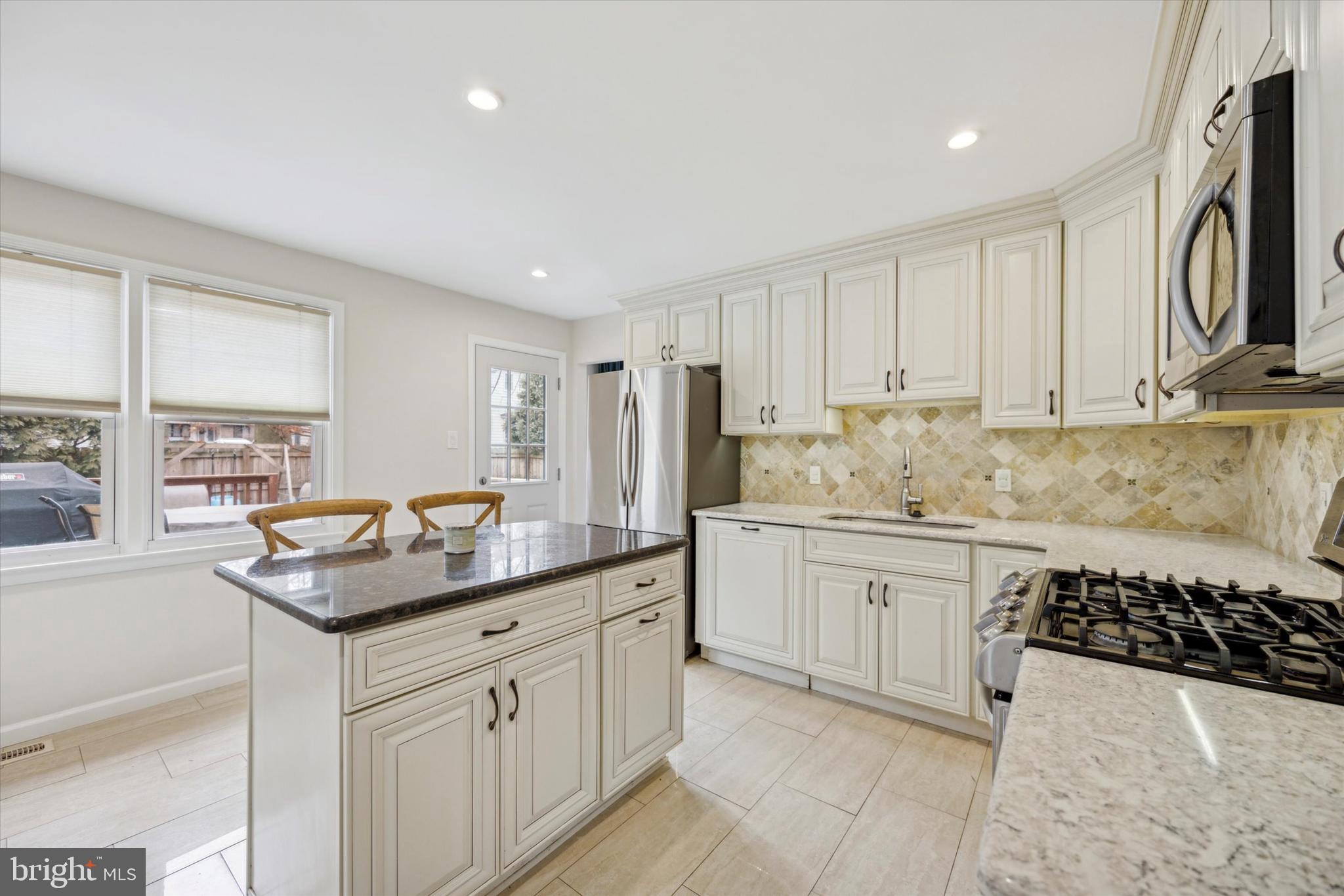 411 Silver Hill Road Cherry Hill, NJ 08002 - Photo 9 of 29 a kitchen with granite countertop a sink a stove and cabinets