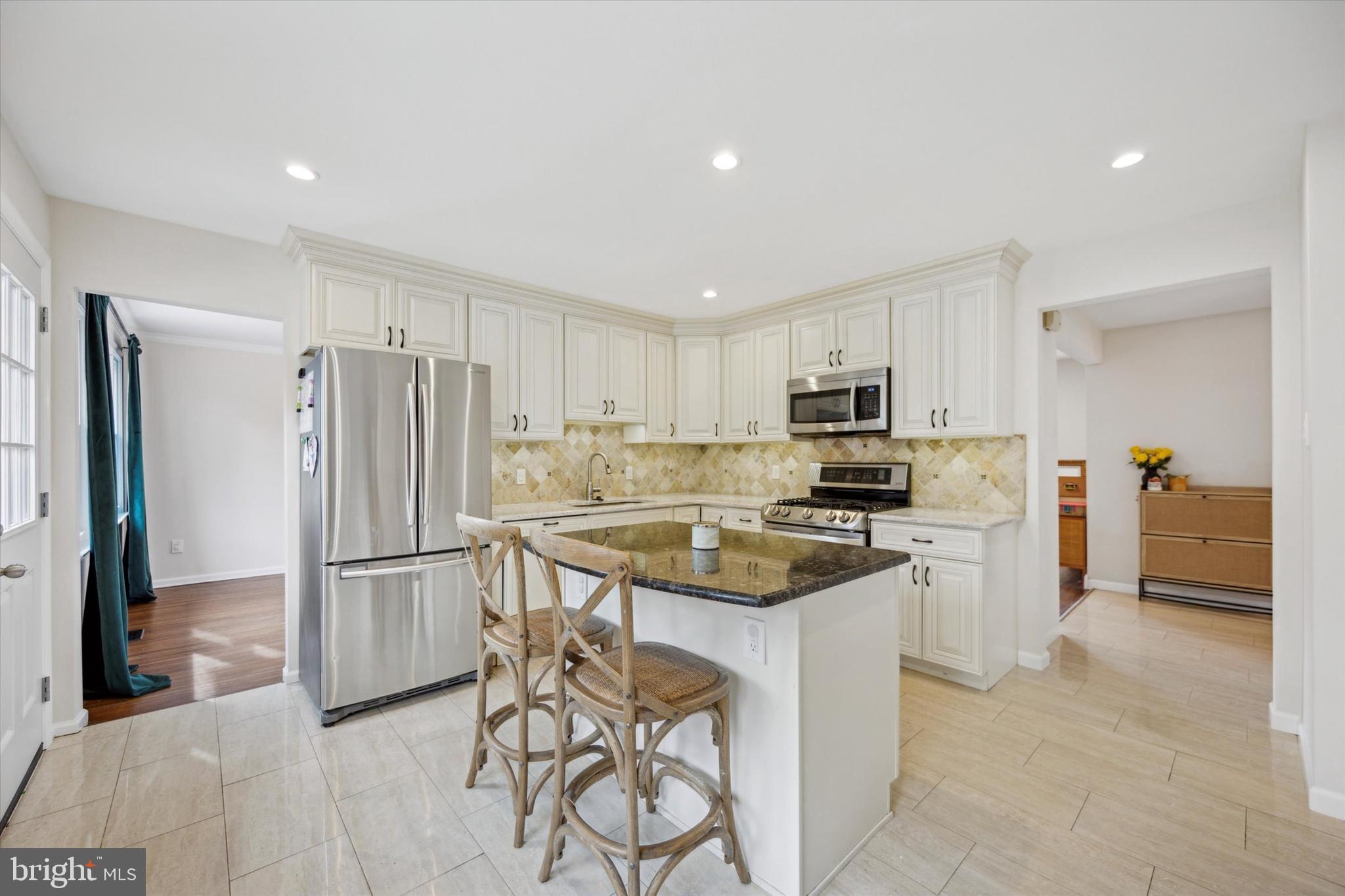 411 Silver Hill Road Cherry Hill, NJ 08002 - Photo 10 of 29 a kitchen with stainless steel appliances granite countertop a refrigerator and a stove top oven