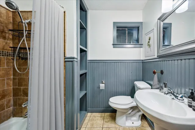 a bathroom with a toilet a sink and shower