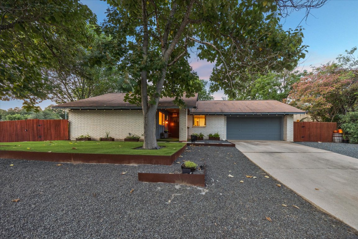 5301 Presidio Road Austin, TX 78745 - Photo 3 of 20 a front view of a house with a yard and a garage