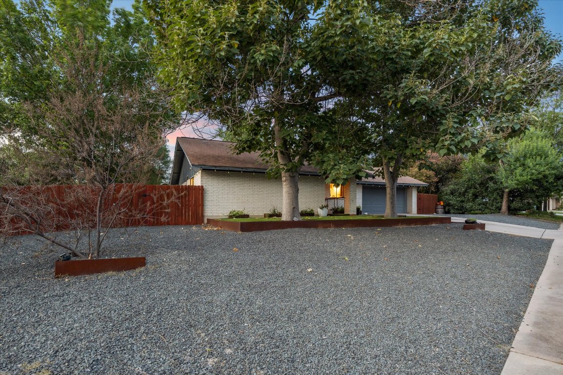5301 Presidio Road Austin, TX 78745 - Photo 4 of 20 a front view of a house with a yard and garage