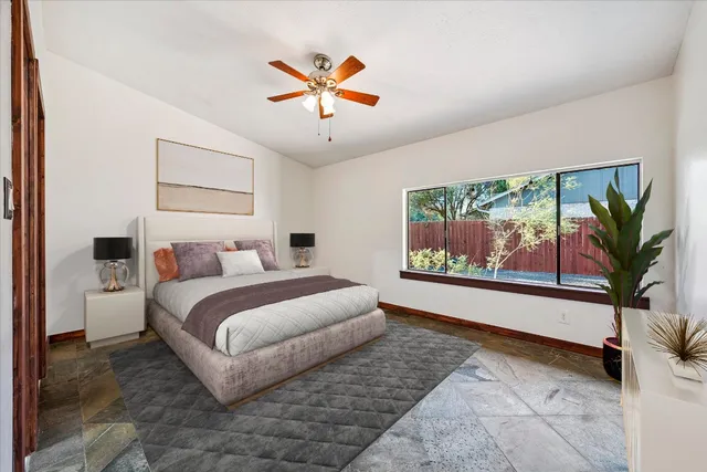 a bedroom with a large bed and a painting on the wall