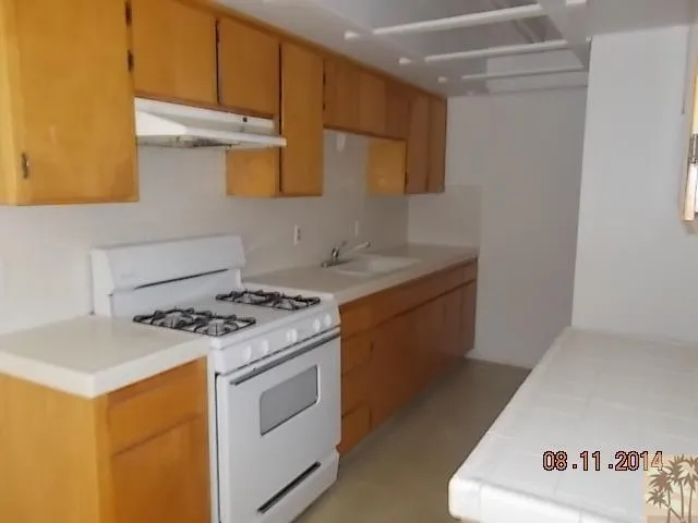a kitchen with a stove and a refrigerator