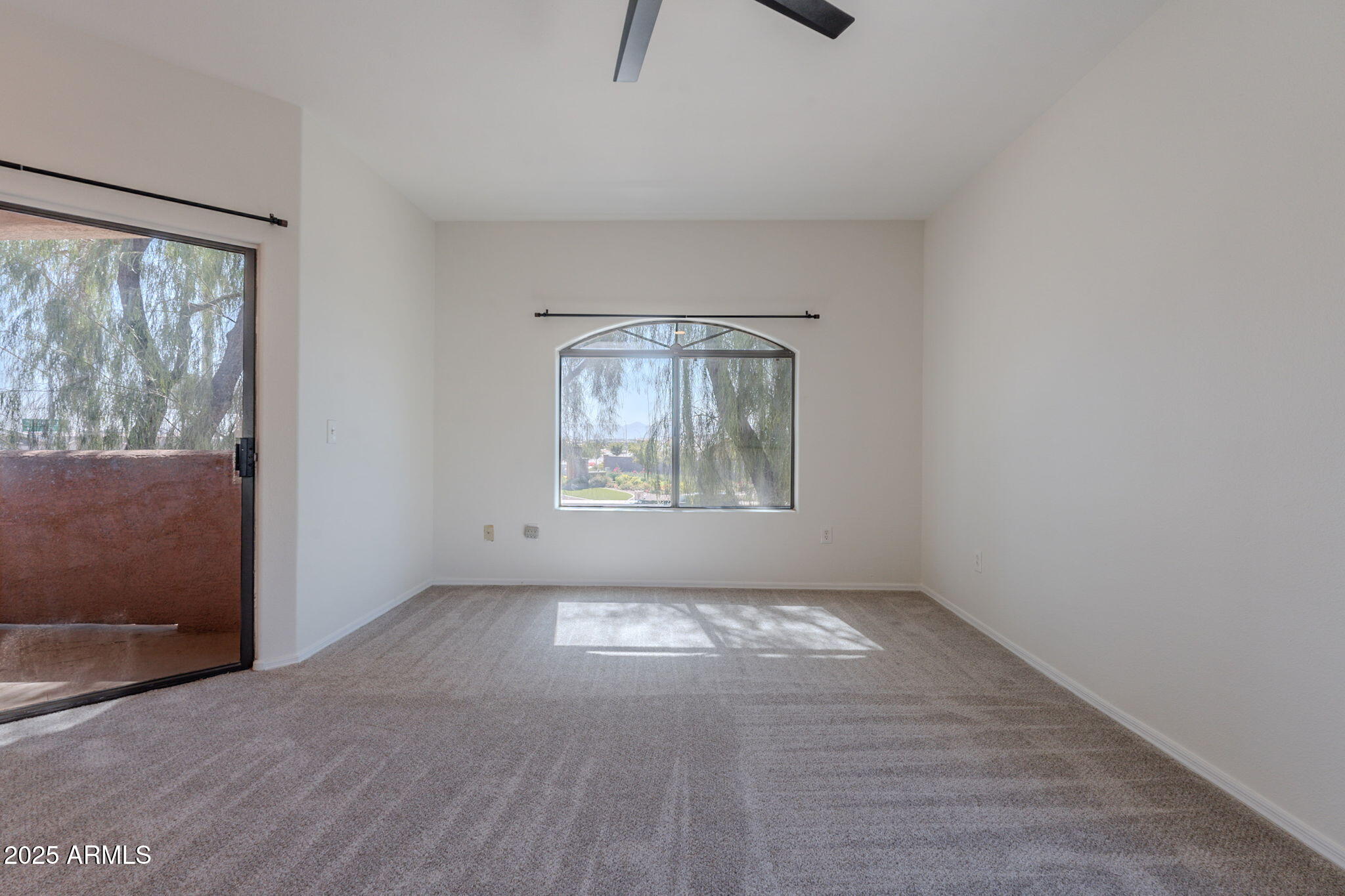 10030 West Indian School Road, Unit 218 Phoenix, AZ 85037 - Photo 9 of 28 an empty room with windows