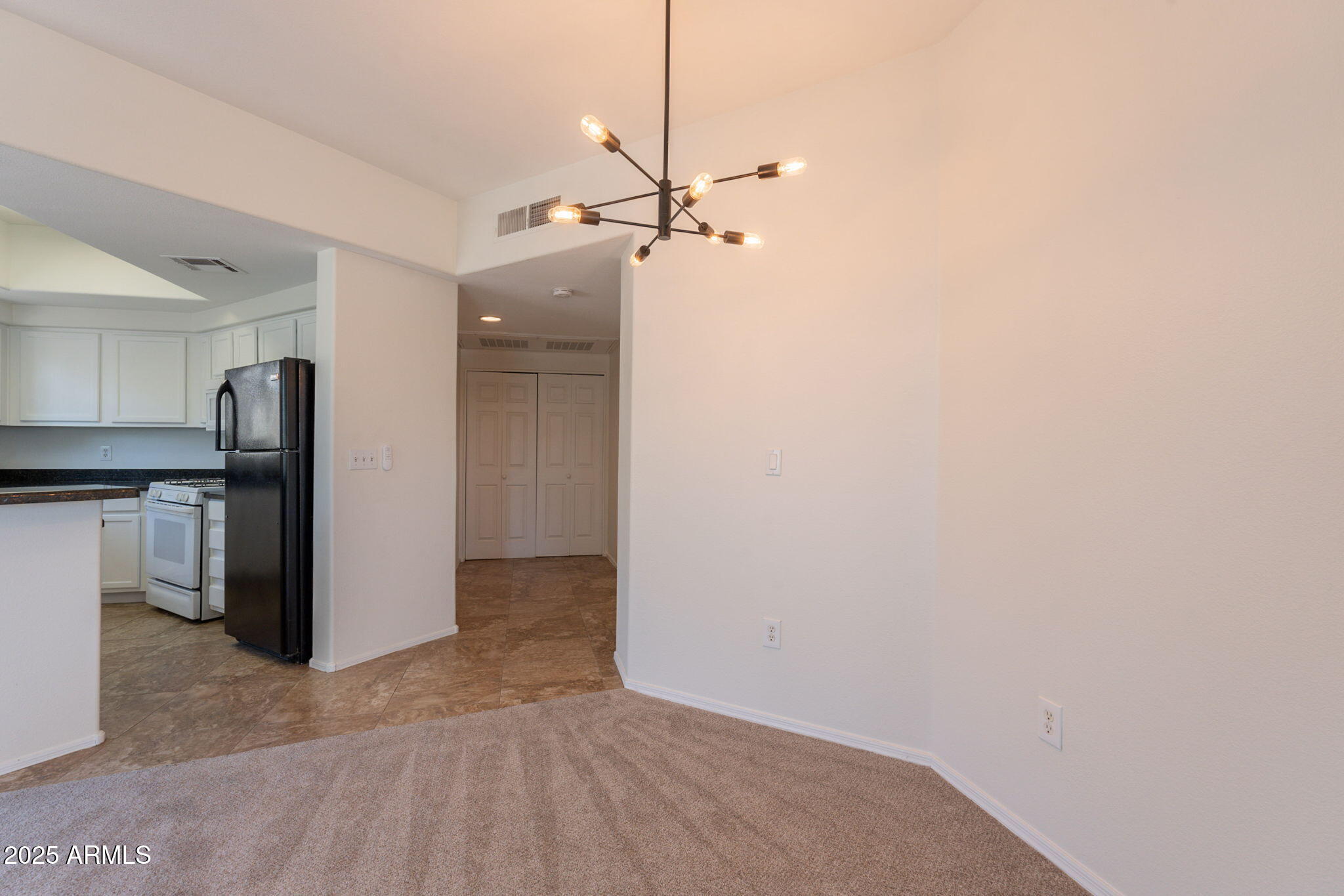 10030 West Indian School Road, Unit 218 Phoenix, AZ 85037 - Photo 13 of 28 a view of a kitchen with a sink and refrigerator