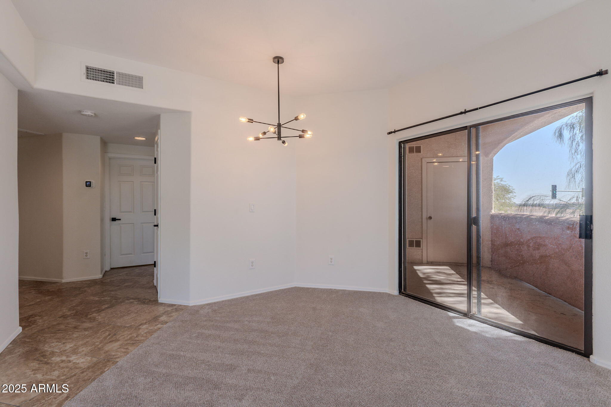 10030 West Indian School Road, Unit 218 Phoenix, AZ 85037 - Photo 14 of 28 a view of empty room with wooden floor and fan