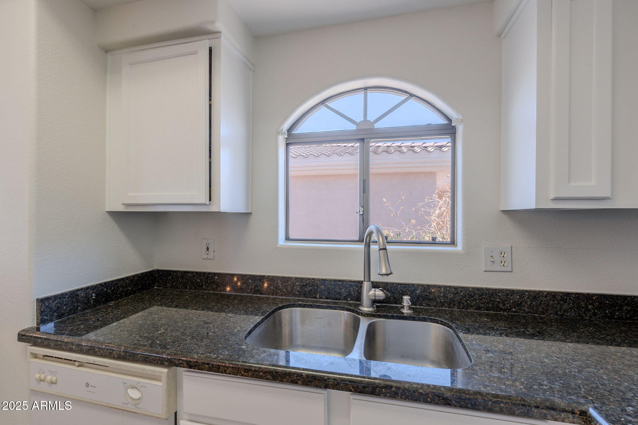 10030 West Indian School Road, Unit 218 Phoenix, AZ 85037 - Photo 5 of 28 a close view of sink a mirror and cabinets