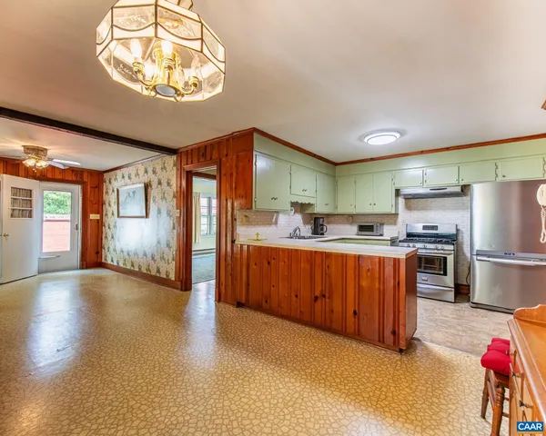 a view of an empty room with window and fire place