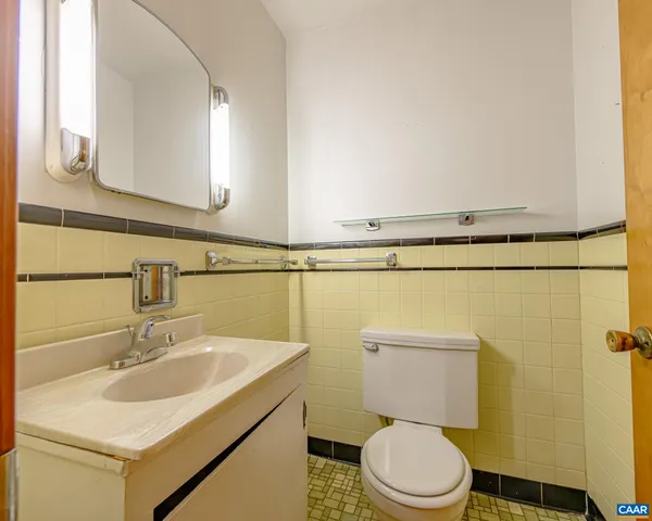 a view of a black and white kitchen with wooden floor