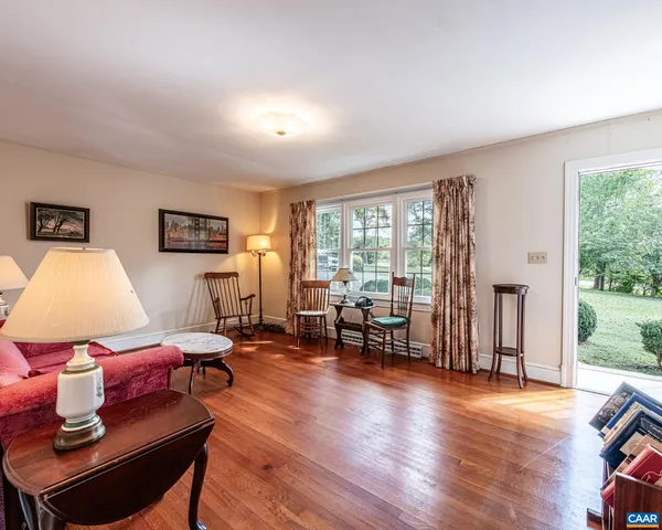 a room with wooden floors and furniture