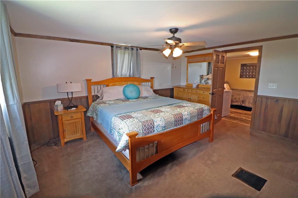 2 Miller Road Mill Run, PA 15464 - Photo 14 of 21 a bedroom with a bed chandelier and a dresser