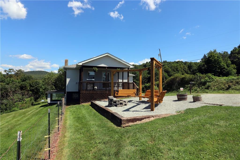 2 Miller Road Mill Run, PA 15464 - Photo 19 of 21 a view of a patio with table and chairs a barbeque grill with potted plants and big yard