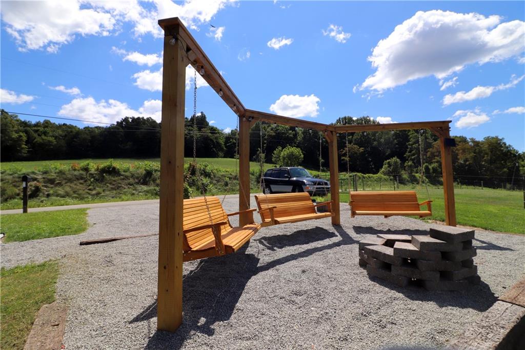 2 Miller Road Mill Run, PA 15464 - Photo 2 of 21 a view of a patio with a table chairs and a backyard