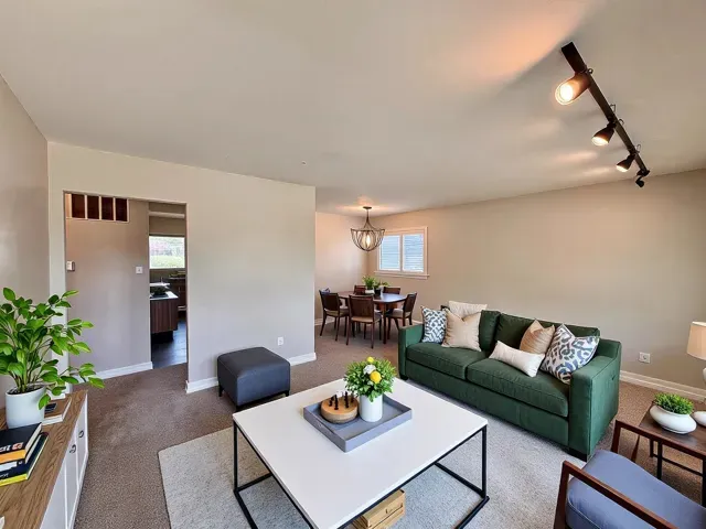 a living room with furniture and flowers