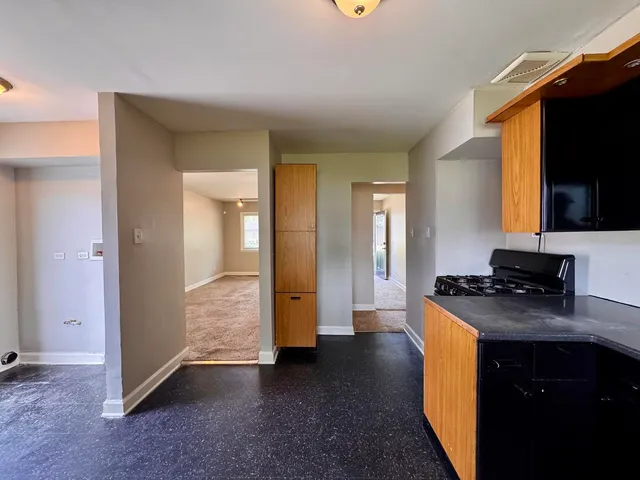 a kitchen with stainless steel appliances granite countertop a stove and a refrigerator
