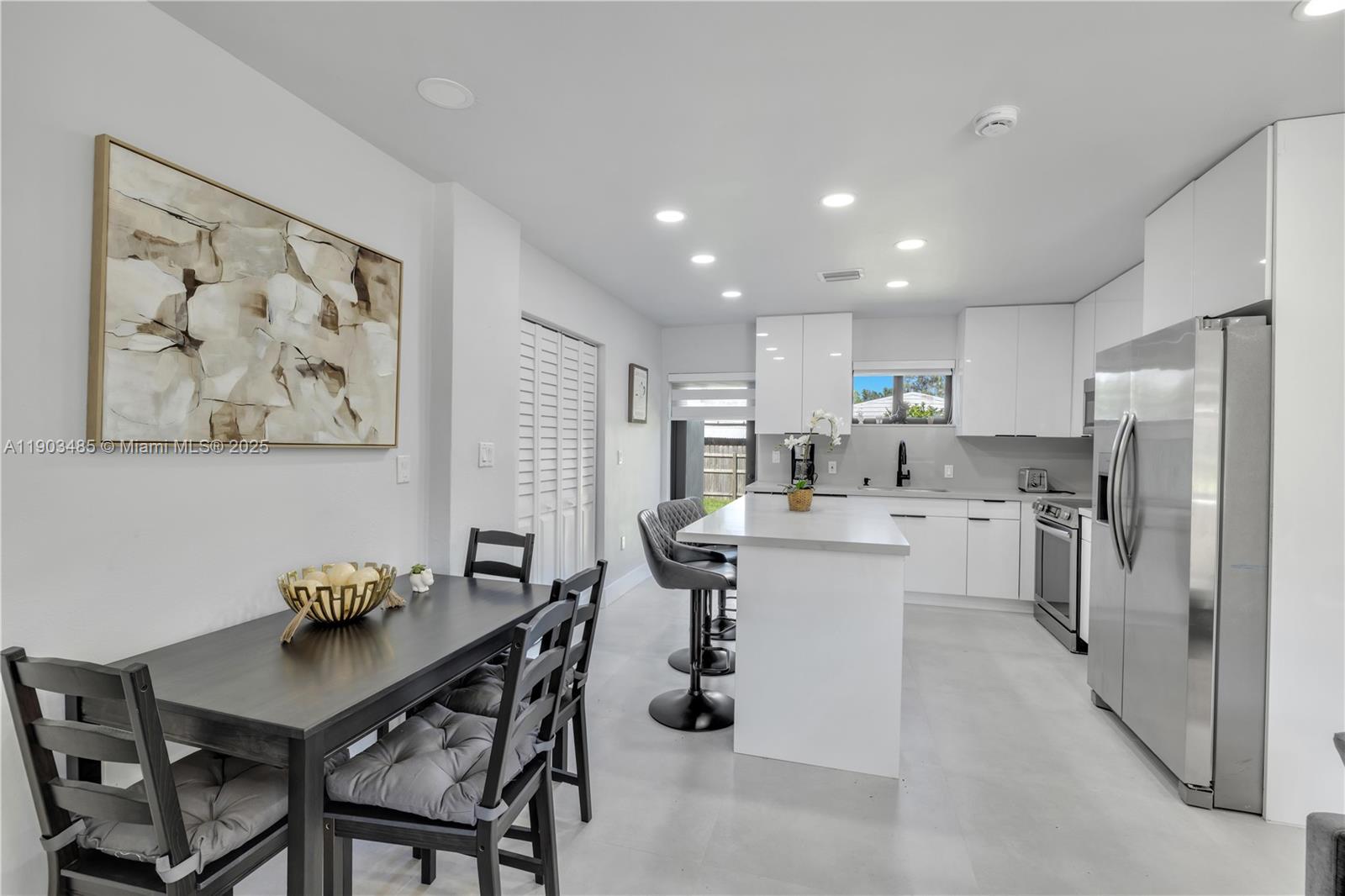 6021 Southwest 19th Street Miami, FL 33155 - Photo 13 of 20 a kitchen with a refrigerator and a table