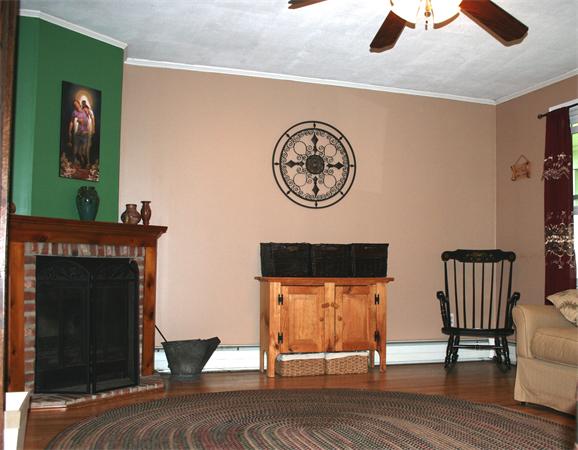 132 Union Road Wales, MA 01081 - Photo 7 of 25 a view of a hallway with wooden floor and a fireplace