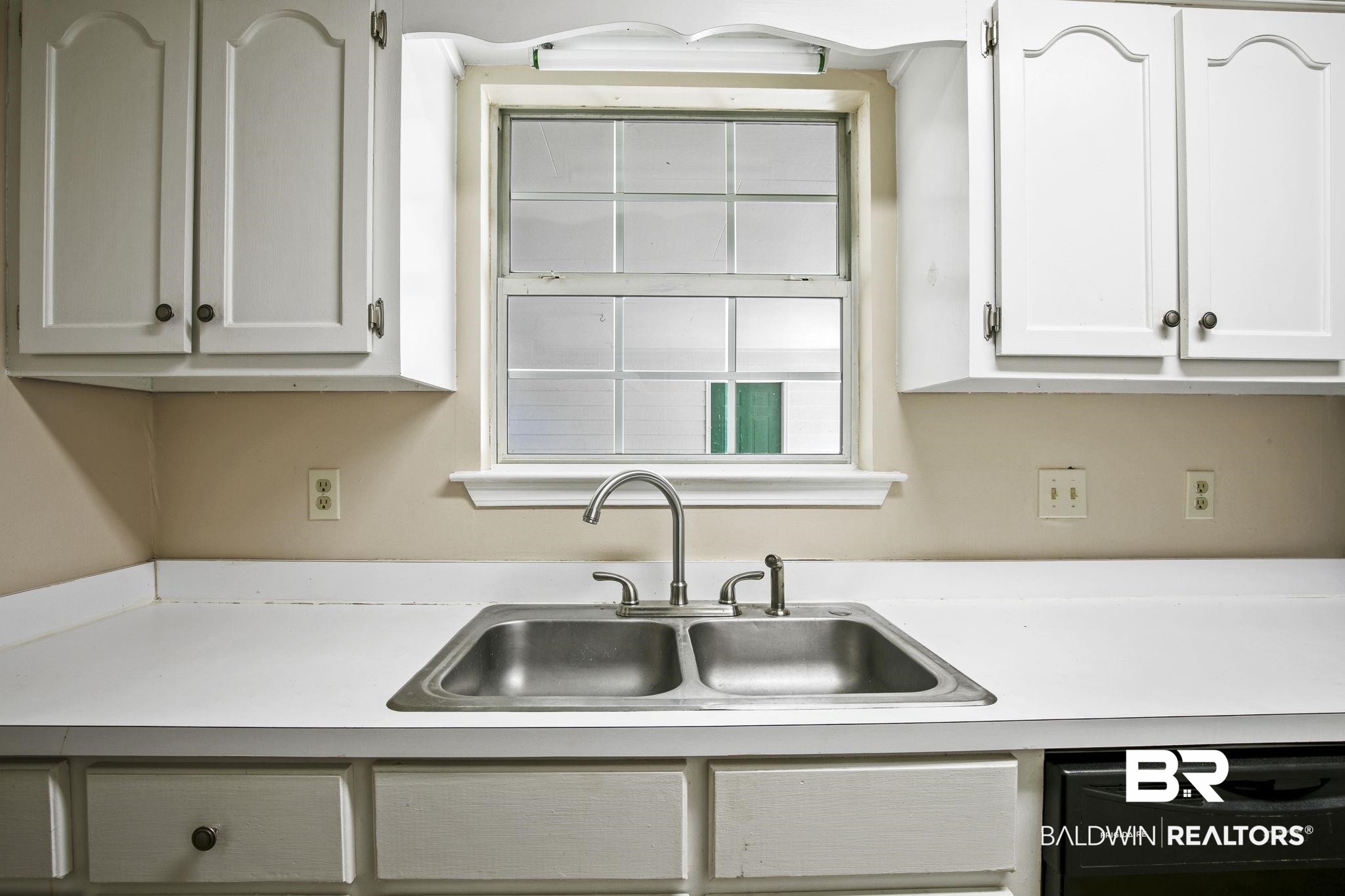 359 Ridgewood Drive Daphne, AL 36526 - Photo 22 of 73 Kitchen with white cabinetry, black dishwasher, and sink