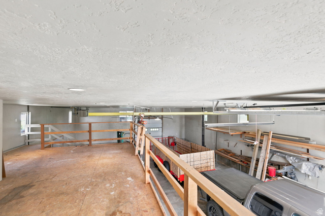 580 North 300 East Logan, UT 84321 - Photo 65 of 74 Spacious loft area with wood flooring and natural wood railings