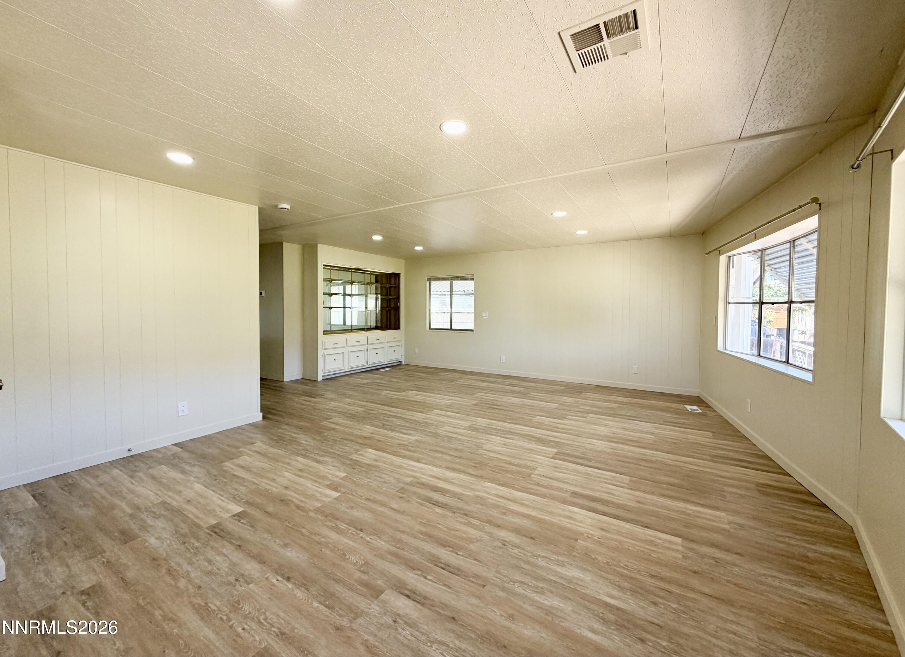 330 Taurus Circle Reno, NV 89521 - Photo 8 of 27 a view of empty room with wooden floor and fan