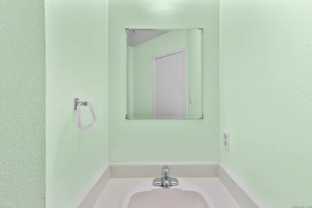 a bathroom with a sink and a mirror