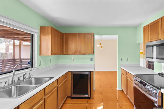 a kitchen with stainless steel appliances granite countertop a sink and a stove