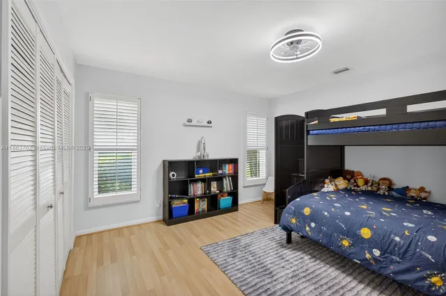 an aerial view of residential houses with outdoor space and trees