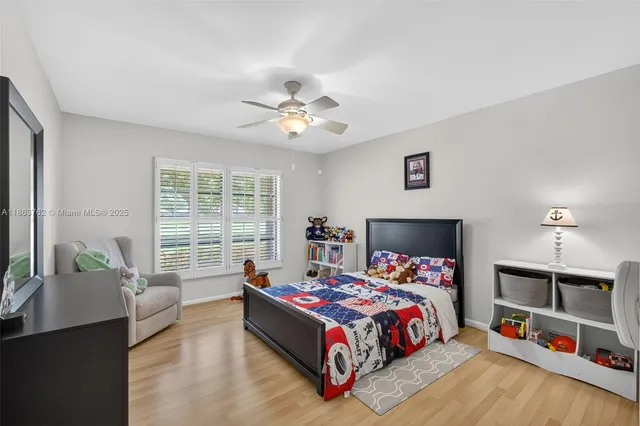 an aerial view of residential houses with outdoor space and trees