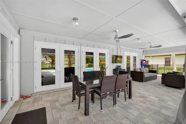 an aerial view of residential houses with outdoor space and trees