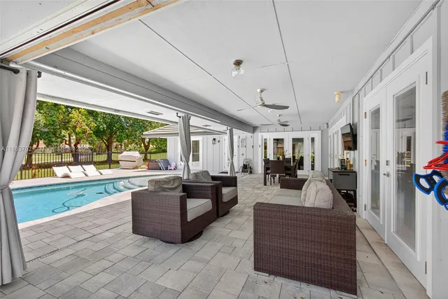 an aerial view of residential houses with outdoor space and trees