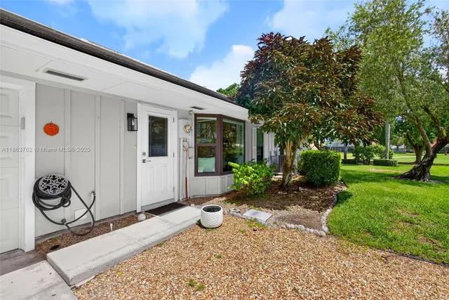 a kitchen with stainless steel appliances kitchen island granite countertop a sink and cabinets