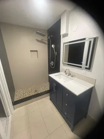 a bathroom with a double vanity sink and mirror