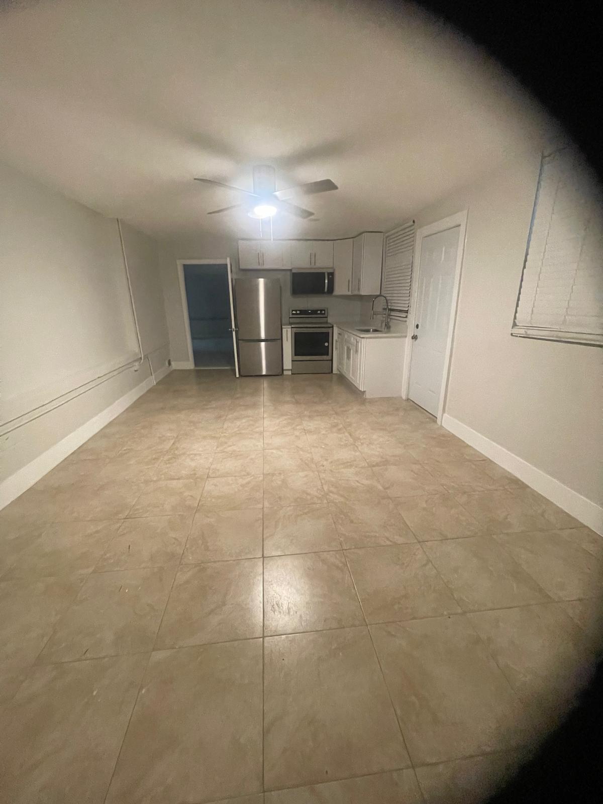1541 1541st Avenue, Unit F Riviera Beach, FL 33404 - Photo 2 of 5 a view of a kitchen with a sink and cabinets