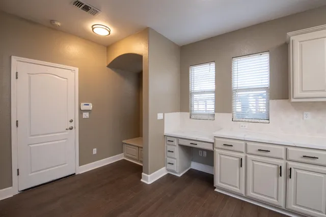 a kitchen with a sink cabinets and wooden floor